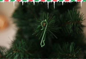 Green S-shaped plastic hooks for hanging Christmas ornaments on tree branches