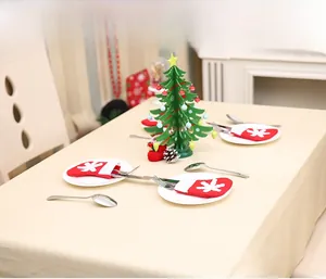 Close-up of red Christmas stocking cutlery holder with snowflake pattern on a plate