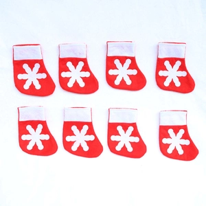 Set of 8 mini red Christmas stockings with white snowflake patterns for cutlery