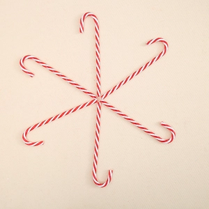 Set of six red and white striped Christmas candy cane ornaments for tree decoration