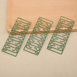 Green plastic S-shaped hooks for Christmas tree ornaments and festive holiday decorations