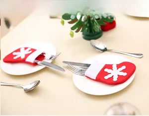 Close-up of red and white Christmas stocking cutlery holders with snowflake details