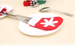 Mini Christmas stocking cutlery holder with snowflake pattern on a white ceramic plate