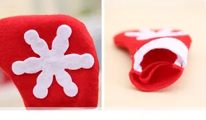 Detail of mini red Christmas stocking cutlery holder with white snowflake and hanging loop
