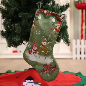 Large green Christmas stocking with reindeer and snowman prints for festive holiday decor
