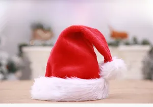 Detailed close-up of plush red velvet Christmas hat with a fluffy white pom-pom on top