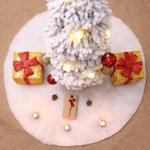 Plush faux fur white Christmas tree skirt decoration on rustic burlap background