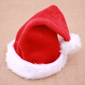 Classic plush red Christmas hat with thick white faux fur trim and pompom on linen background