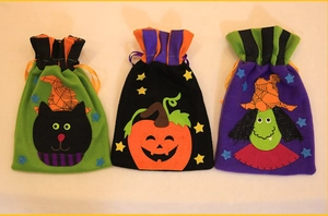 Three-pack Halloween drawstring gift bags featuring black cat, pumpkin, and witch designs