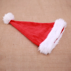 Classic plush red Santa hat with thick white faux fur trim on burlap background