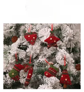 Close-up of knitted Christmas ornaments featuring stars and socks on a snowy tree