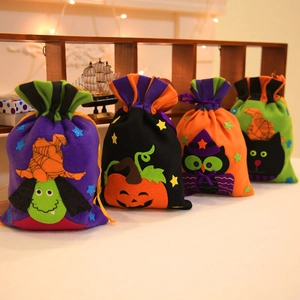 Halloween gift bags with witch and pumpkin designs on a festive wooden shelf display