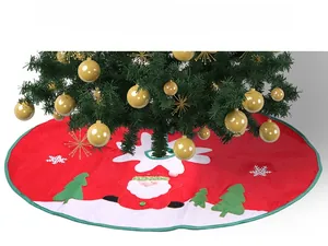Detailed view of red Christmas tree skirt with Santa Claus applique and snowflake embroidery