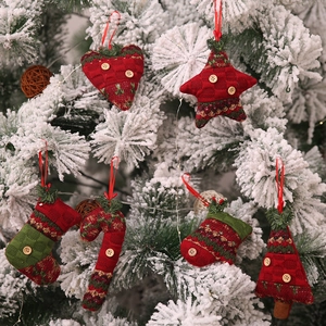 Knitted Christmas ornaments set with heart, star, and stocking hanging on a tree