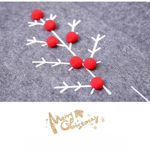 Detail of grey felt Christmas tree skirt with 3D red pompom berries and white branch motifs