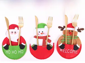 Close-up of Santa, Snowman, and Reindeer felt cutlery holders for Christmas table decor