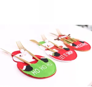 Detailed close-up of Santa, Snowman and Reindeer felt cutlery bags with gold silverware