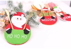 Close-up of Santa Claus cutlery holder with festive embroidery and red felt pockets