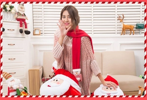 Close-up of a festive red knit Christmas scarf featuring a cute 3D snowman and Santa doll