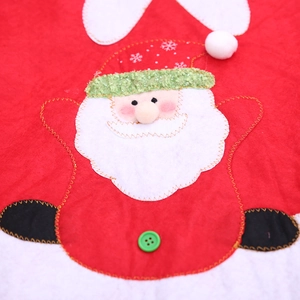 Red non-woven Christmas tree skirt featuring Santa Claus felt appliqué and green button detail
