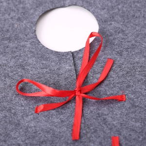 Grey felt Christmas tree skirt featuring a vibrant red satin ribbon bow tie detail