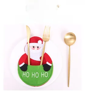 Detail view of Santa Claus felt cutlery holder with HO HO HO embroidery on a plate