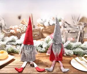 Close-up of festive Christmas gnomes with striped legs and long hats for bottle decor