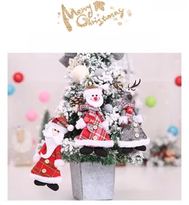 Detail of fabric Christmas ornaments with Santa and reindeer on a snowy tree