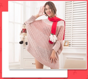 Detail of red festive scarf with 3D Santa Claus figure paired with pink chunky knit sweater