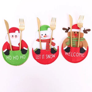 Christmas silverware holders featuring Santa, Snowman and Reindeer with HO HO HO text