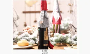 Side view of festive gnome wine bottle covers in red and grey plush knit fabric