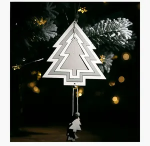 Macro shot of 3D layered hollow wooden Christmas tree ornament with elegant warm bokeh