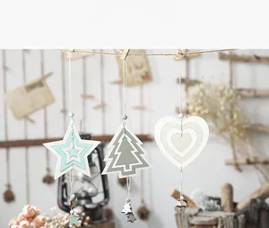 Three-piece Nordic wooden holiday ornaments in star, tree, and heart shapes with hanging strings