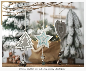 Detailed view of Nordic geometric wooden Christmas ornaments on a rustic tree branch