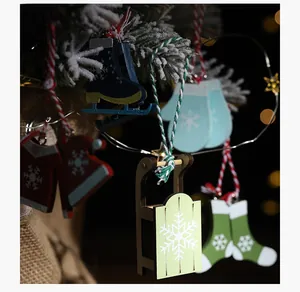 Detailed view of wood Christmas ornaments including red sweater and skis on tree