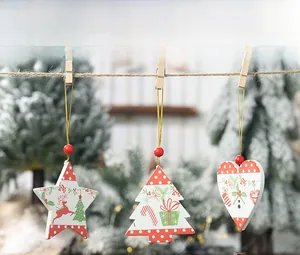 Detail view of wooden Christmas ornaments with reindeer and tree prints on a rustic rope