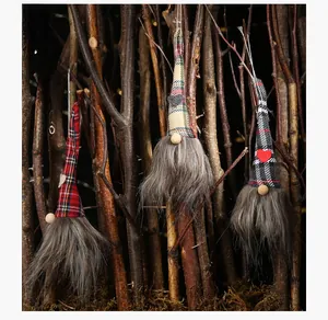 Group of three festive Christmas gnomes with plaid hats and heart patches on wood