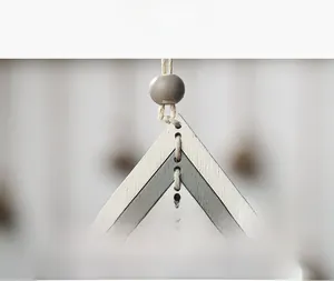 Close-up of laser-cut wooden Christmas ornament with multi-layer design and hanging rope
