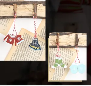 Detailed view of wood painted Christmas ornaments featuring sweater and skate shapes