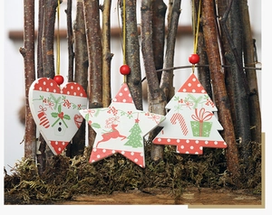 Close-up of wooden Christmas ornaments featuring heart, star and tree shapes in Nordic style
