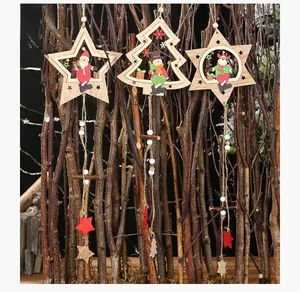 Detail of wooden Christmas ornaments with laser-cut star and tree shapes hanging on branches