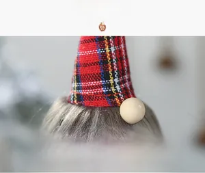 Close-up of Christmas gnome detail with plaid hat, plush beard and wooden nose