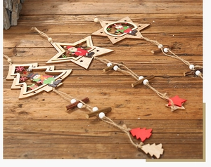 Detail of wooden Christmas star ornaments with reindeer and Santa prints on rustic background