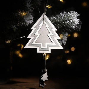 Three-layer hollow wooden Christmas tree ornament with beads hanging on a festive tree branch