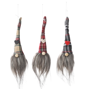 Three Christmas gnome ornaments with plaid hats and long white beards on a white background