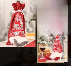 Close-up of gnome wine bottle covers with reindeer knit hats and white faux fur beards
