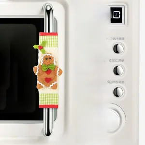Detailed Christmas gingerbread man handle cover on microwave with plaid fabric and holly leaf