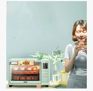 Detail view of a mint green countertop oven with three layers of fresh baked goods inside