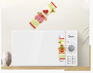 Detail of gingerbread man microwave handle covers in festive red and green plaid