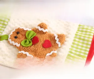 Detail of Christmas handle cover featuring waffle fabric and plush gingerbread man motif